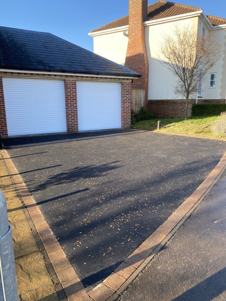 tarmac driveway with a light block edging and gravel resin coated chips