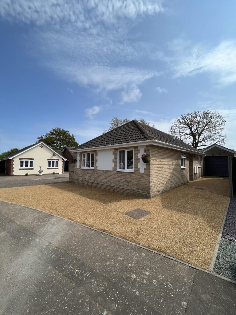 A bungalow with a tar and chip driveway built using k170 tar and a 6mm natural norfolk golden gravel