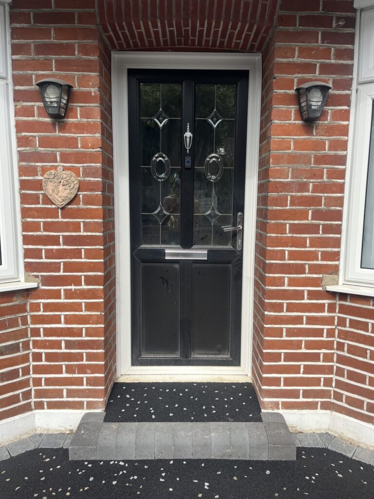 New Tarmac front step with grey chip, with a charcoal border block