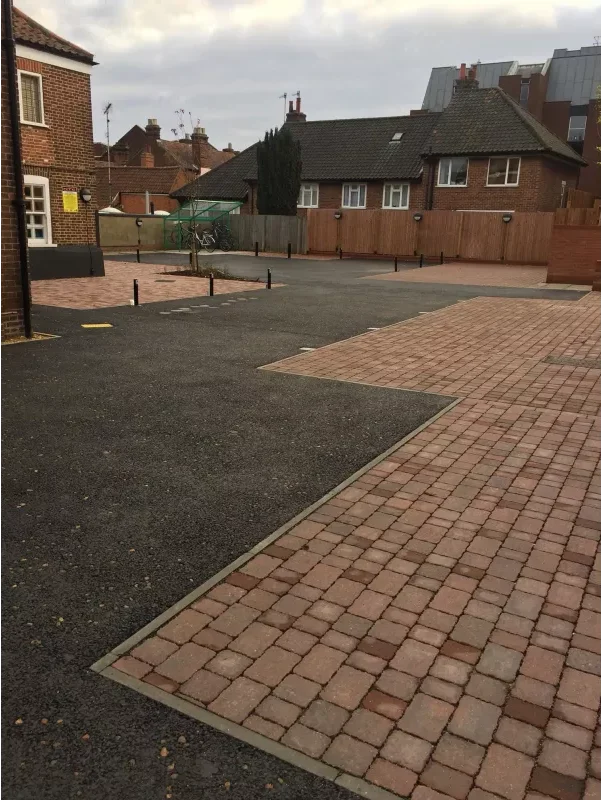 Tarmac car park in Norwich with permeable brick weave parking bays